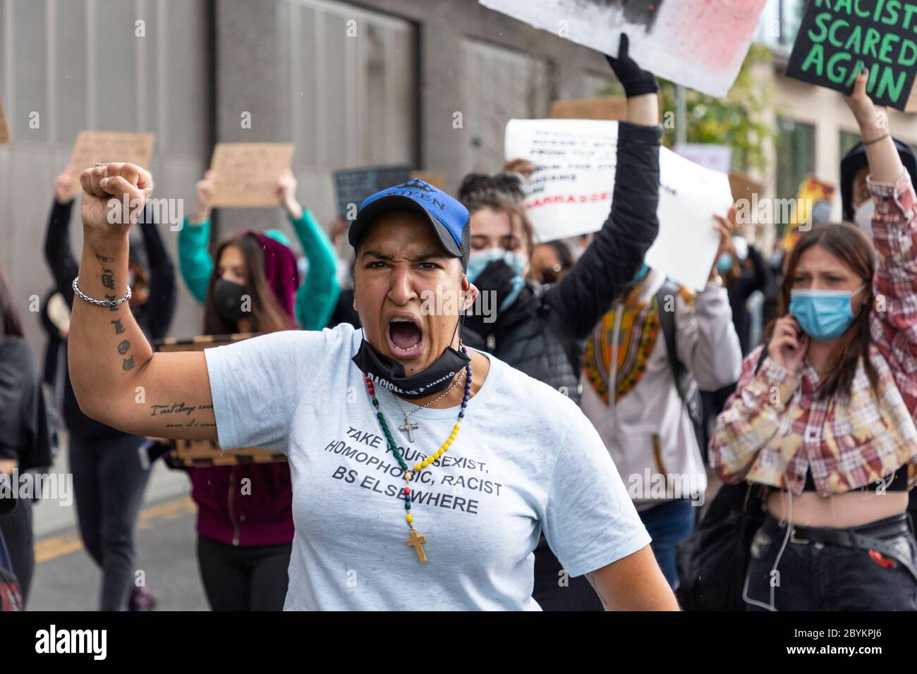 A protester raises her fist outside the US embassy during a Black Lives Matters protest, Nine Elms, London, 7 June 2020 Stock Photo