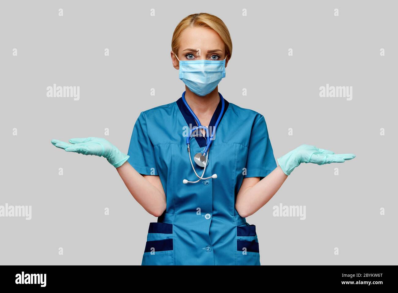 medical doctor nurse woman with stethoscope wearing protective mask and rubber or latex gloves Stock Photo