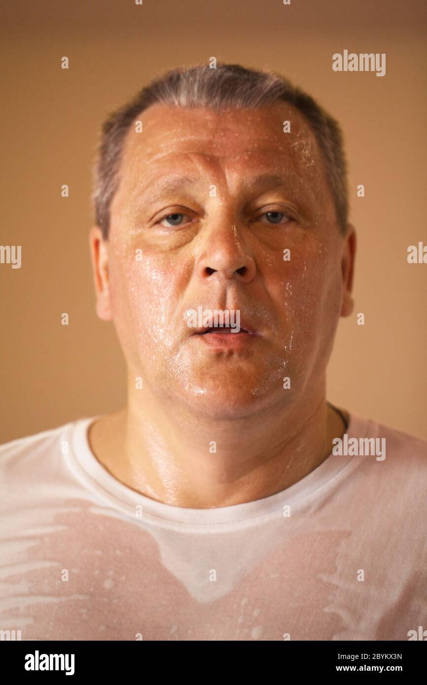 Tired looking middle-aged man after a workout Stock Photo