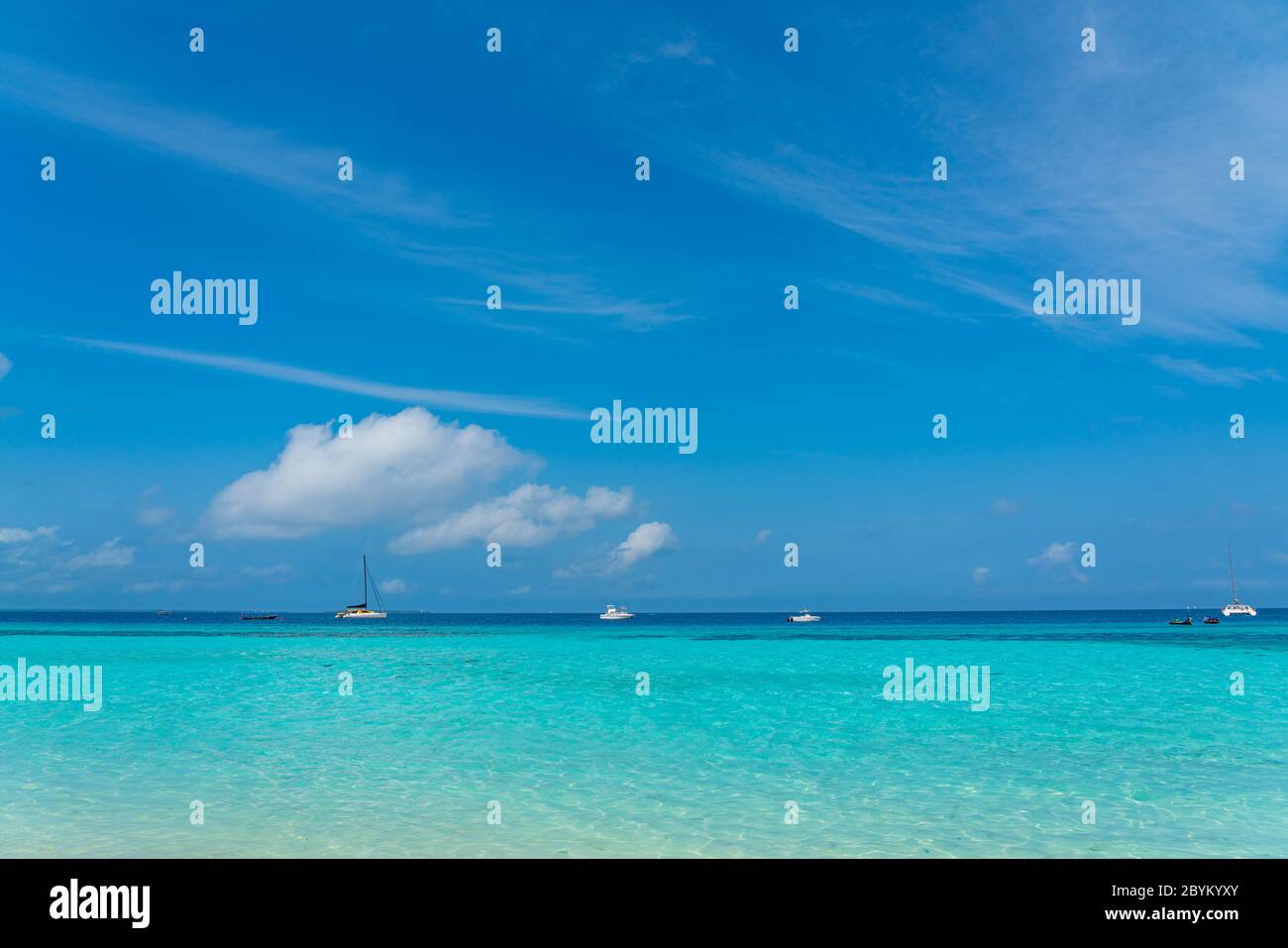 Boats on turquoise Ocean with White Sand blue Sky at Zanzibar Island, Tanzania Stock Photo