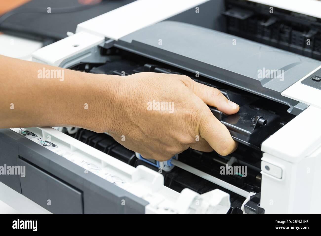 Technicians replacing toner in laser printer concept office supplies repair Stock Photo