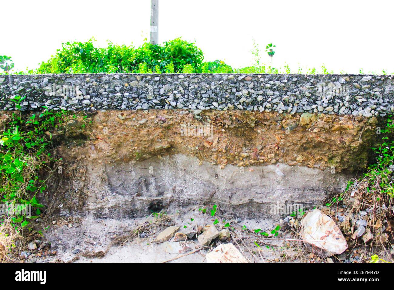 damage the asphalt road cut of soil layer with different visible ...