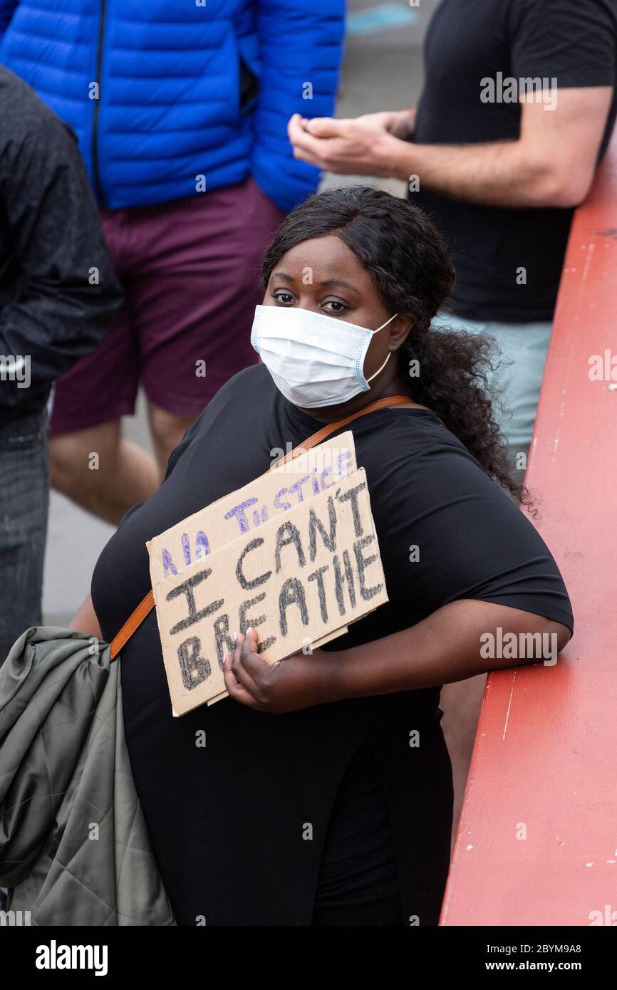 A black woman holds a sign on Vauxhall bridge during a Black Lives Matters protest, London, 7 June 2020 Stock Photo