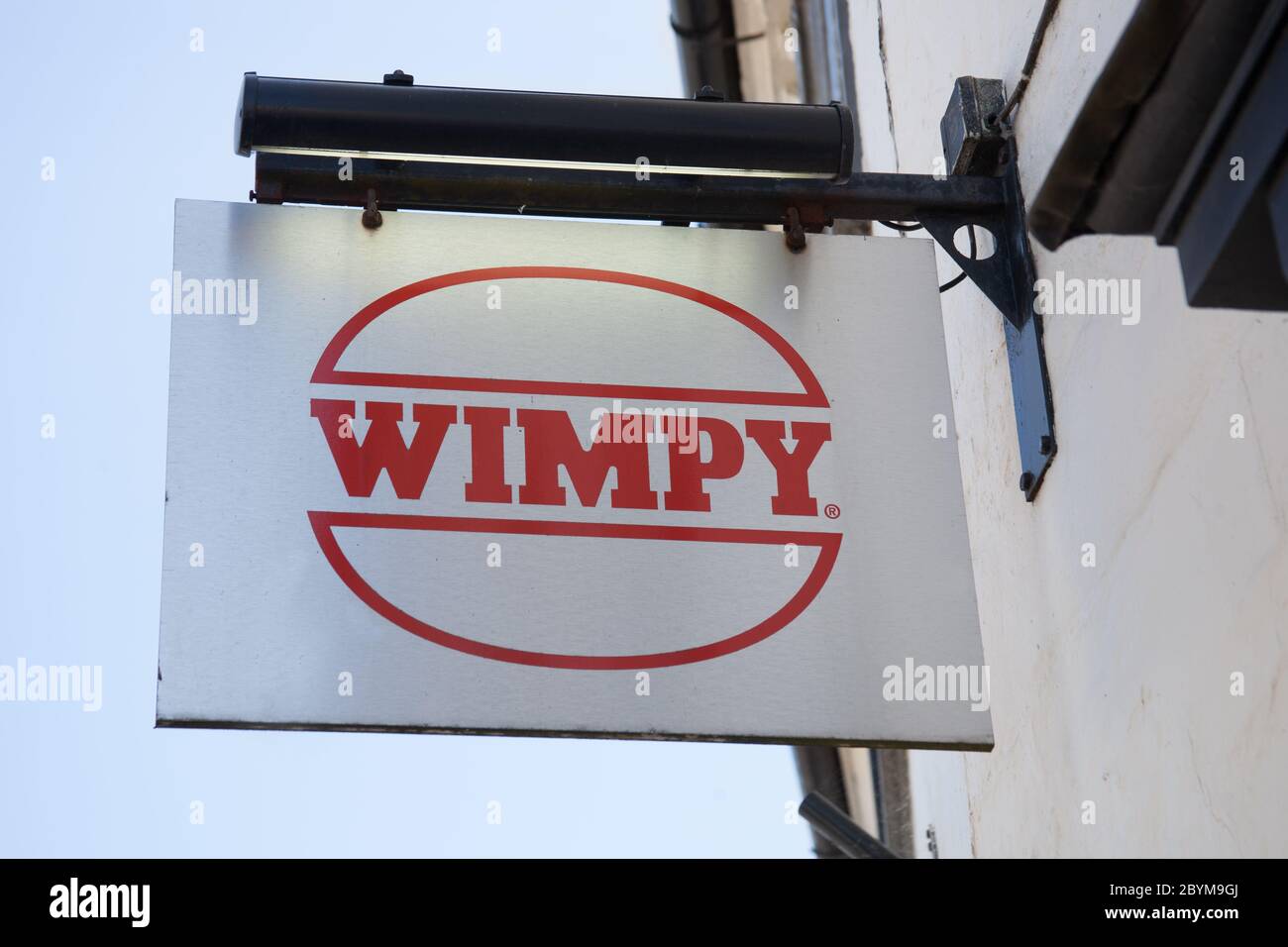 The Wimpy restaurant sign hanging from a wall in the UK Stock Photo
