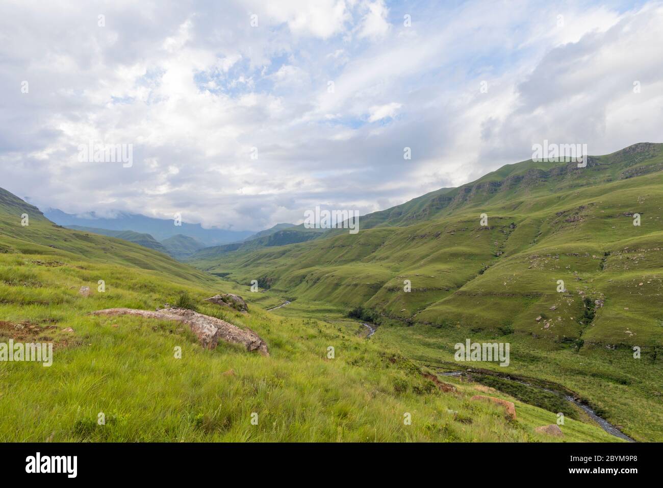 Clouds over green valley in the mountain Stock Photo - Alamy