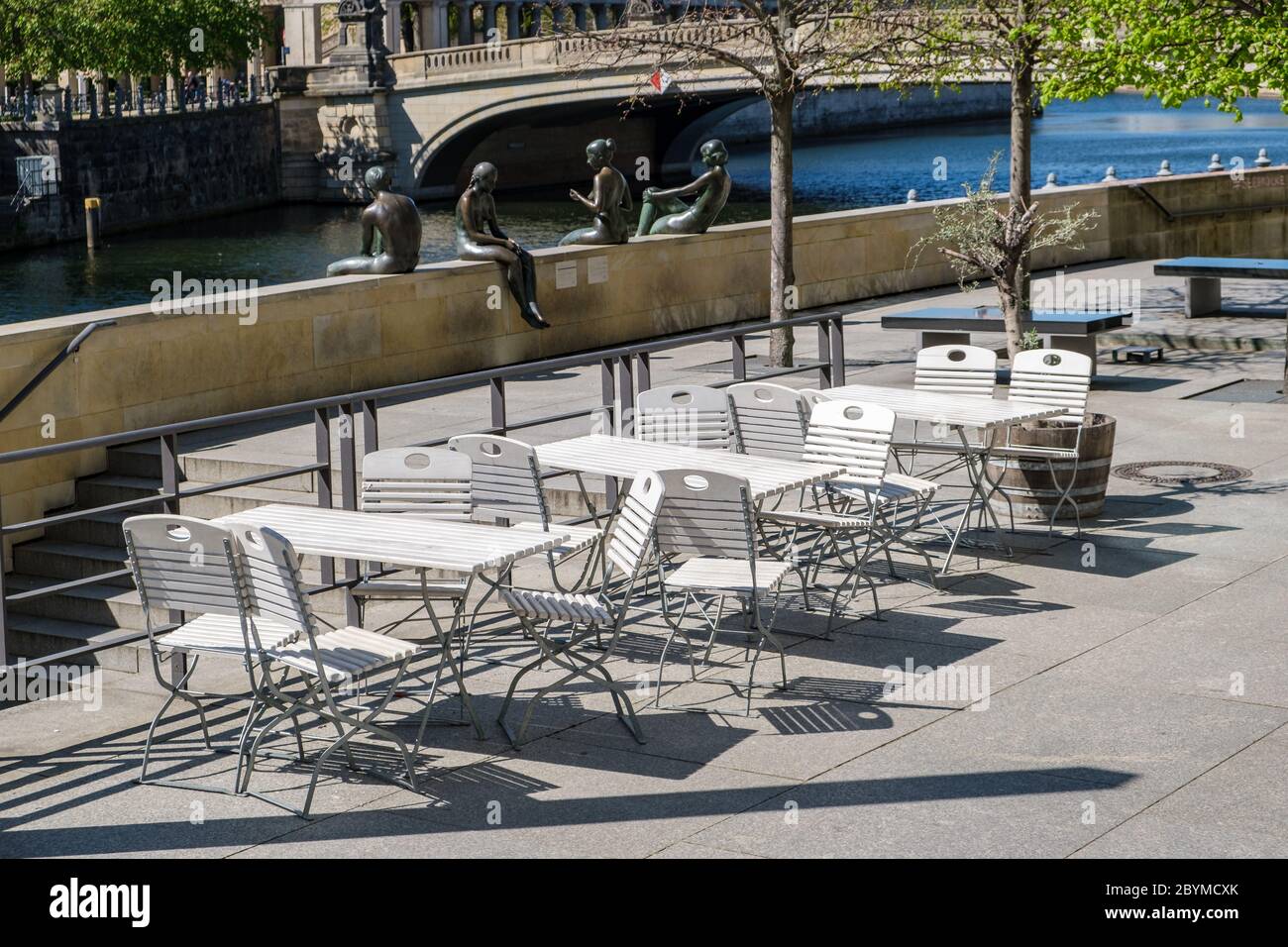 19.04.2020, Berlin, Berlin, Germany - The vacant chairs of a closed restaurant opposite the Berlin Cathedral will not be occupied during springlike te Stock Photo