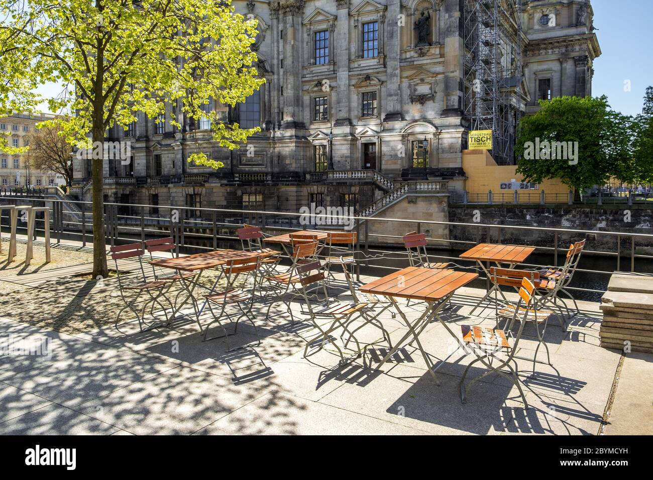 19.04.2020, Berlin, Berlin, Germany - The vacant chairs of a closed restaurant opposite the Berlin Cathedral will not be occupied during springlike te Stock Photo