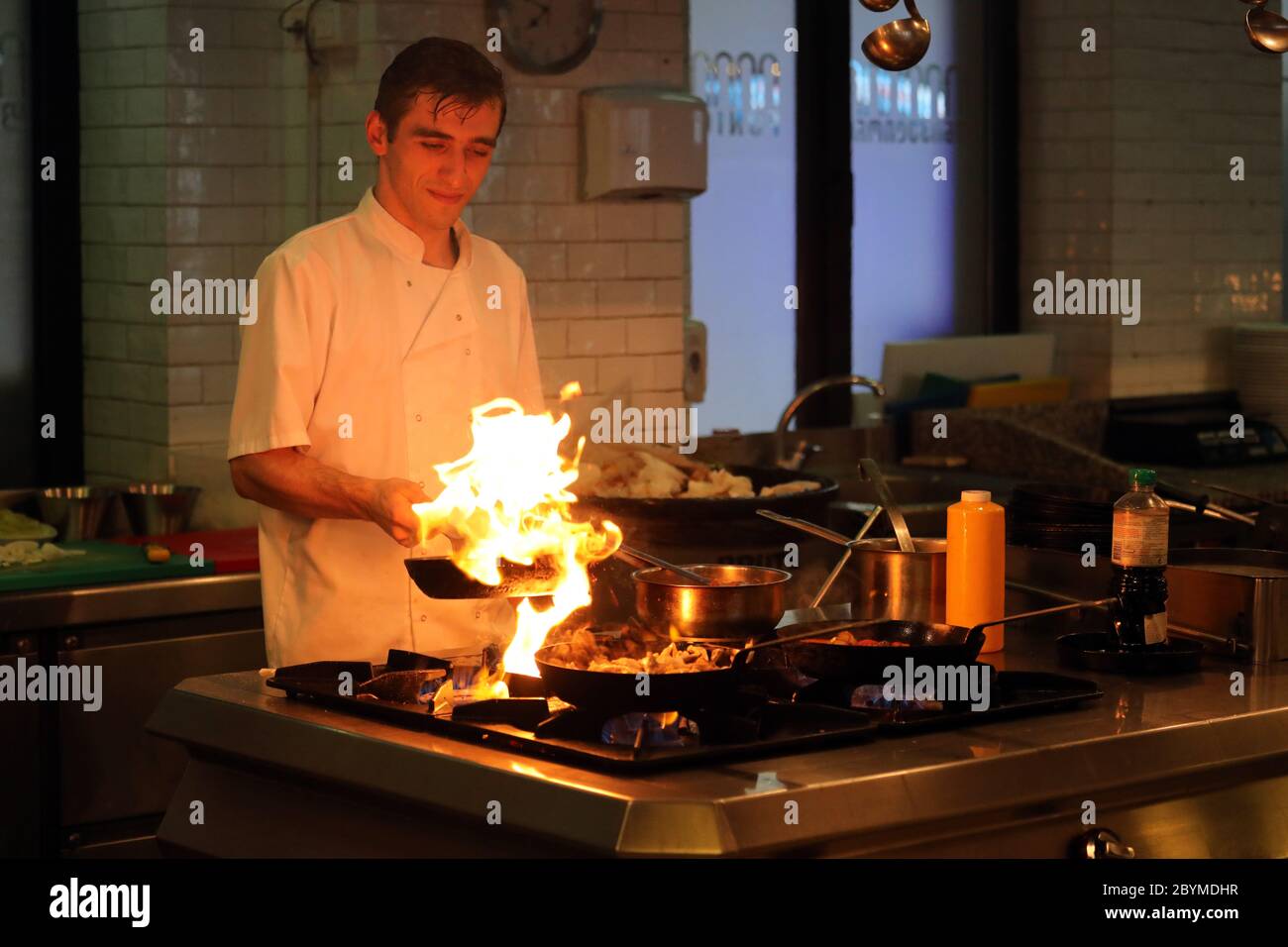 20.07.2018, Tbilisi, , Georgia - Cook flambing food in a pan. 00S180720D073CAROEX.JPG [MODEL RELEASE: NO, PROPERTY RELEASE: NO (c) caro images / Sorg Stock Photo