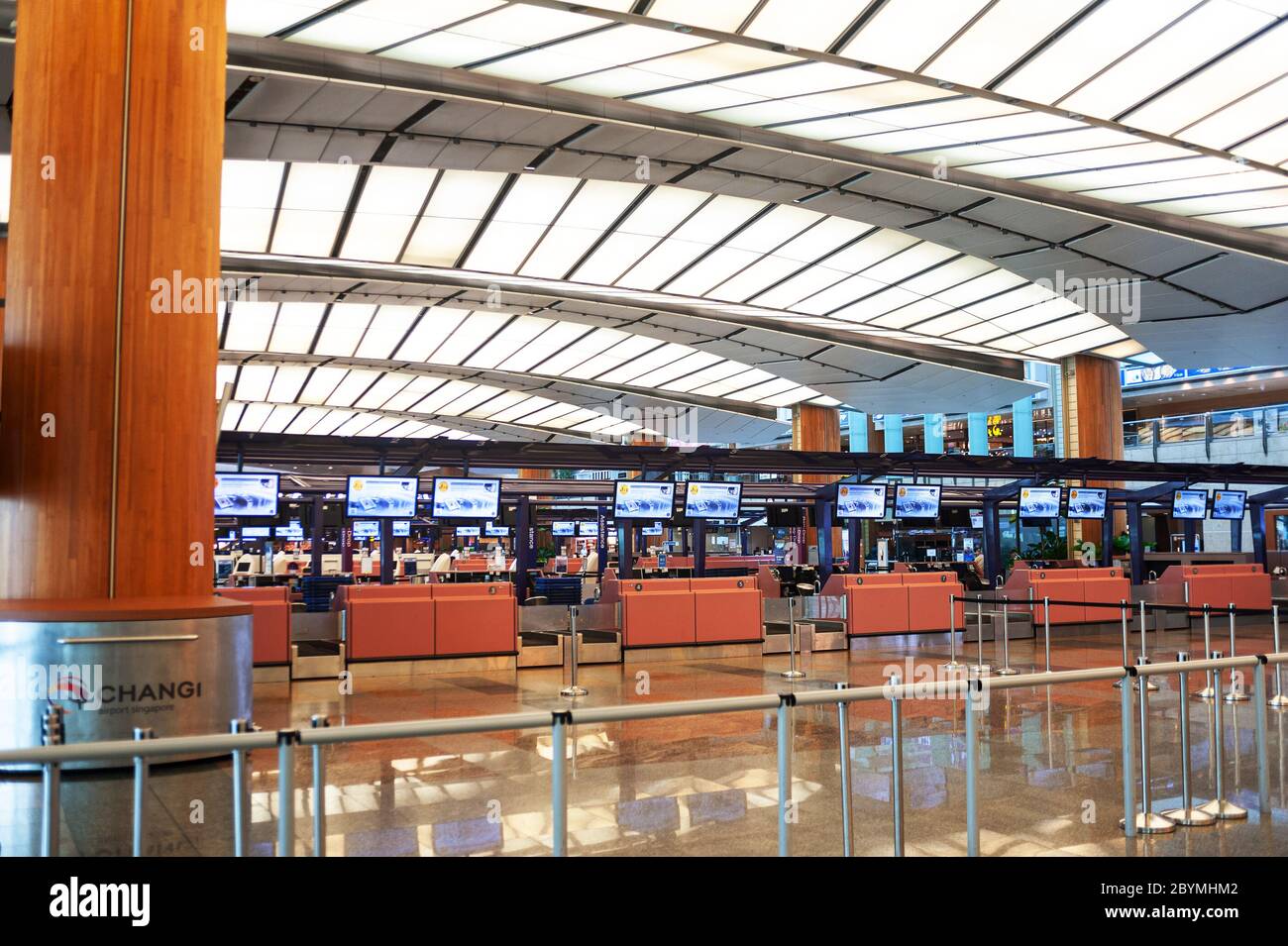 28.03.2020, Singapore, , Singapore - Closed departure counters in the empty departure hall of Terminal 2 at Changi Airport. The global spread of the c Stock Photo