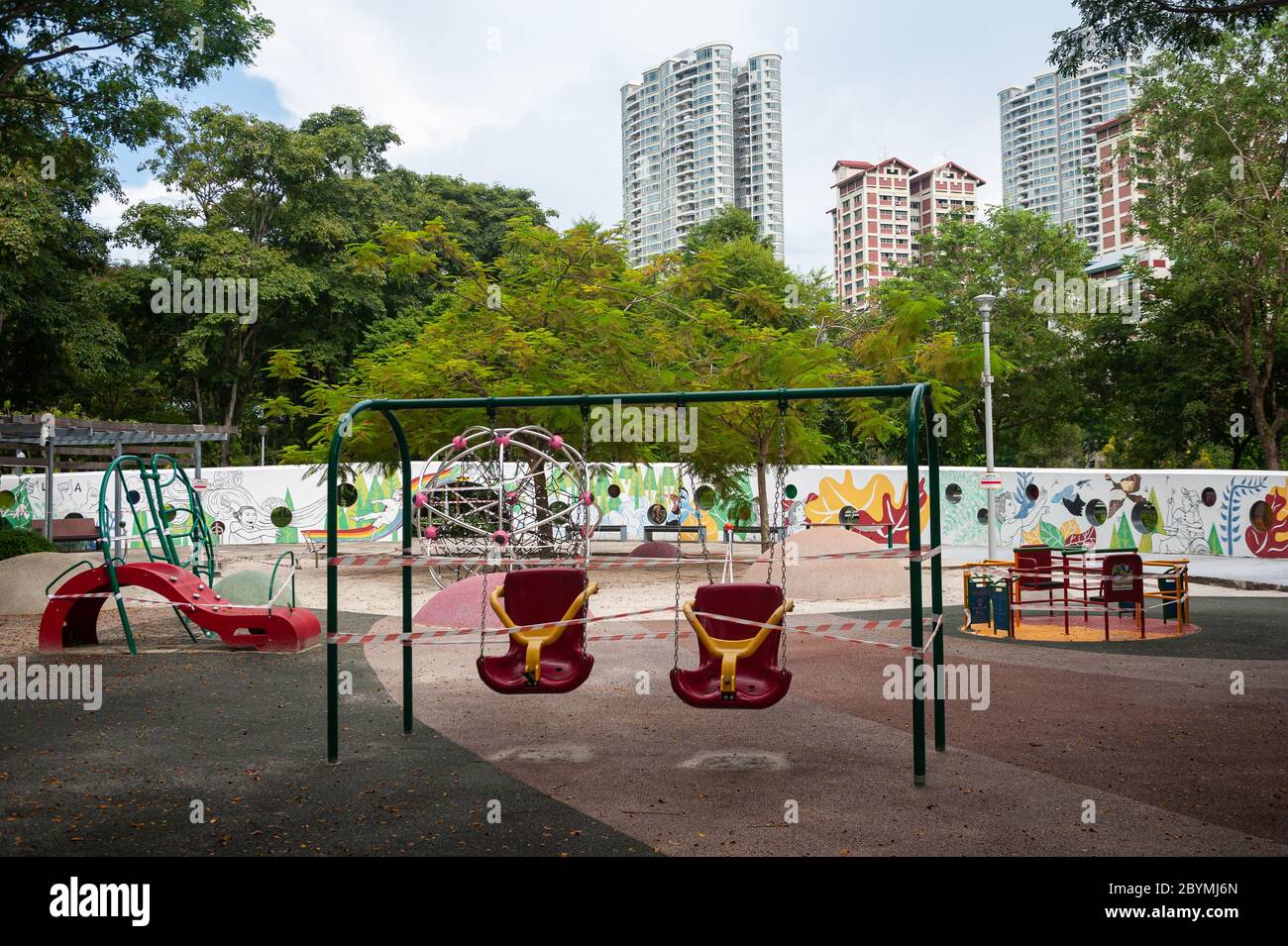 28.05.2020, Singapore, , Singapore - Swings and other playground equipment have been sealed with red and white tape in a playground in Bishan-Ang Mo K Stock Photo