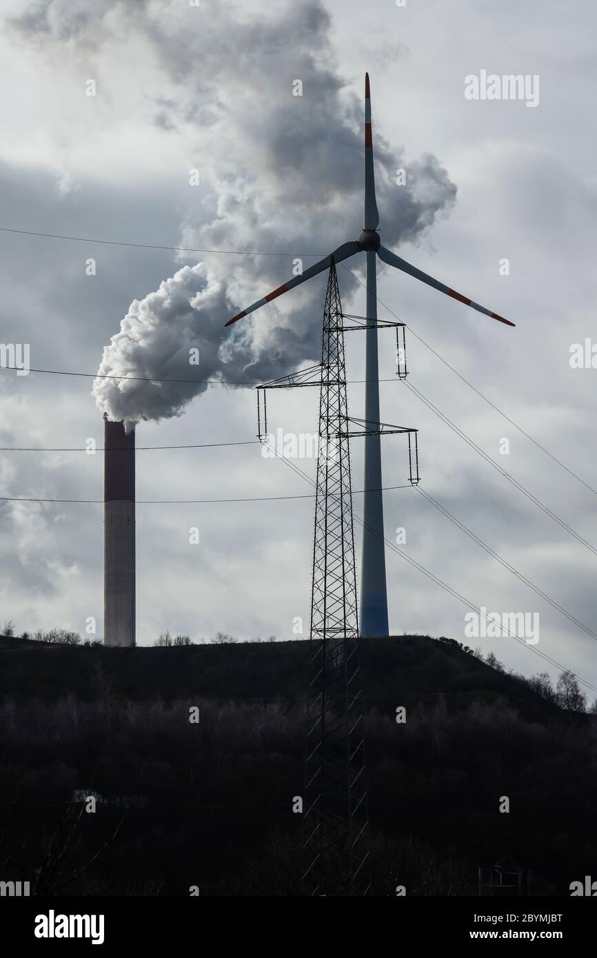 04.05.2020, Gelsenkirchen, North Rhine-Westphalia, Germany - Energy landscape, wind turbines, power pole and smoking chimneys at Scholven power statio Stock Photo