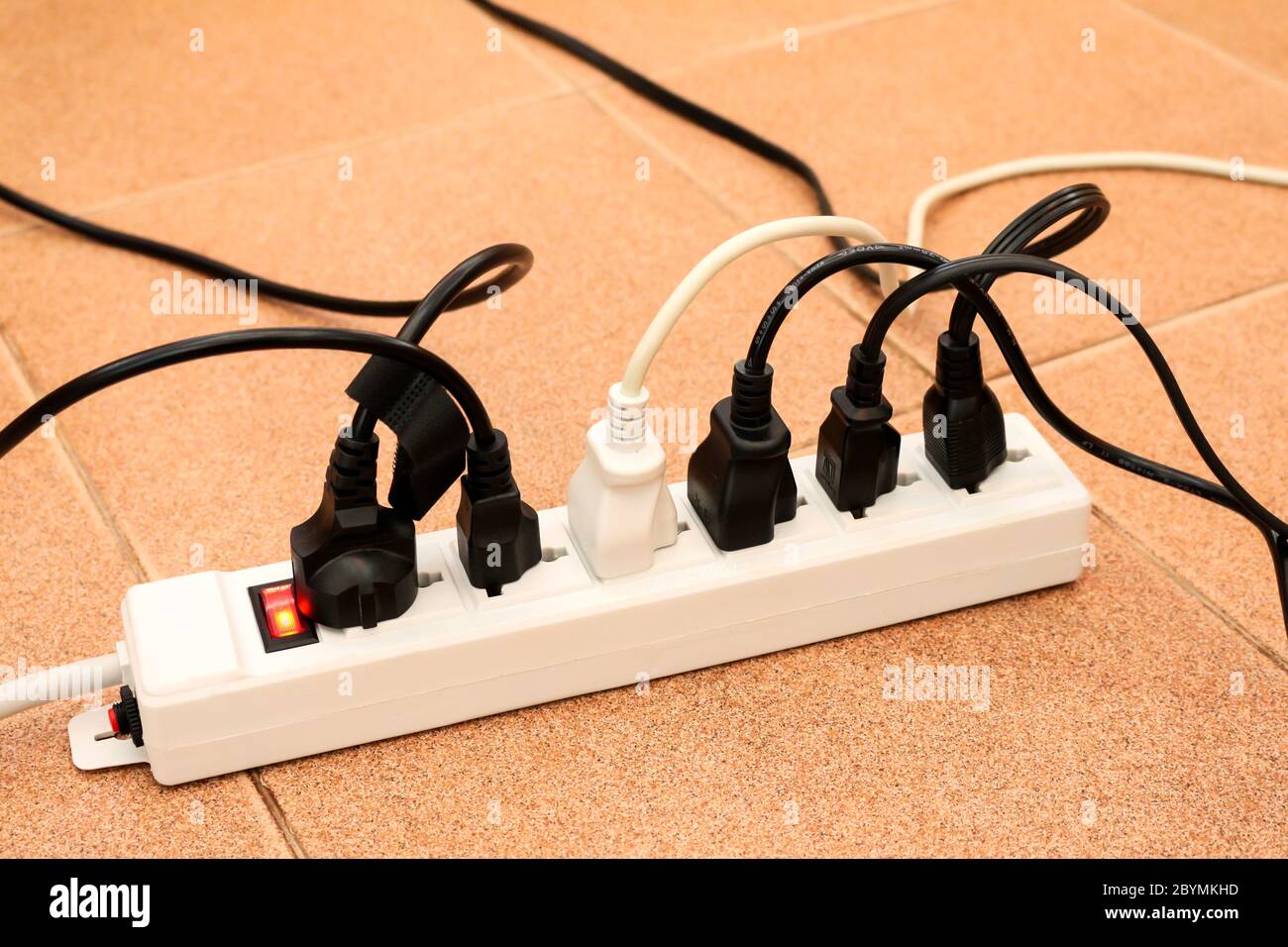 overloaded power boards outlet multiple socket electrical plug Stock Photo