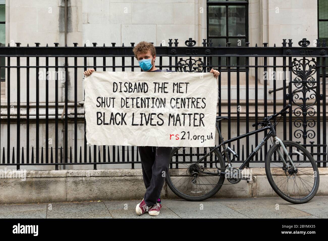 A young white man holds up a banner during a Black Lives Matters protest, Parliament Square, London, 7 June 2020 Stock Photo