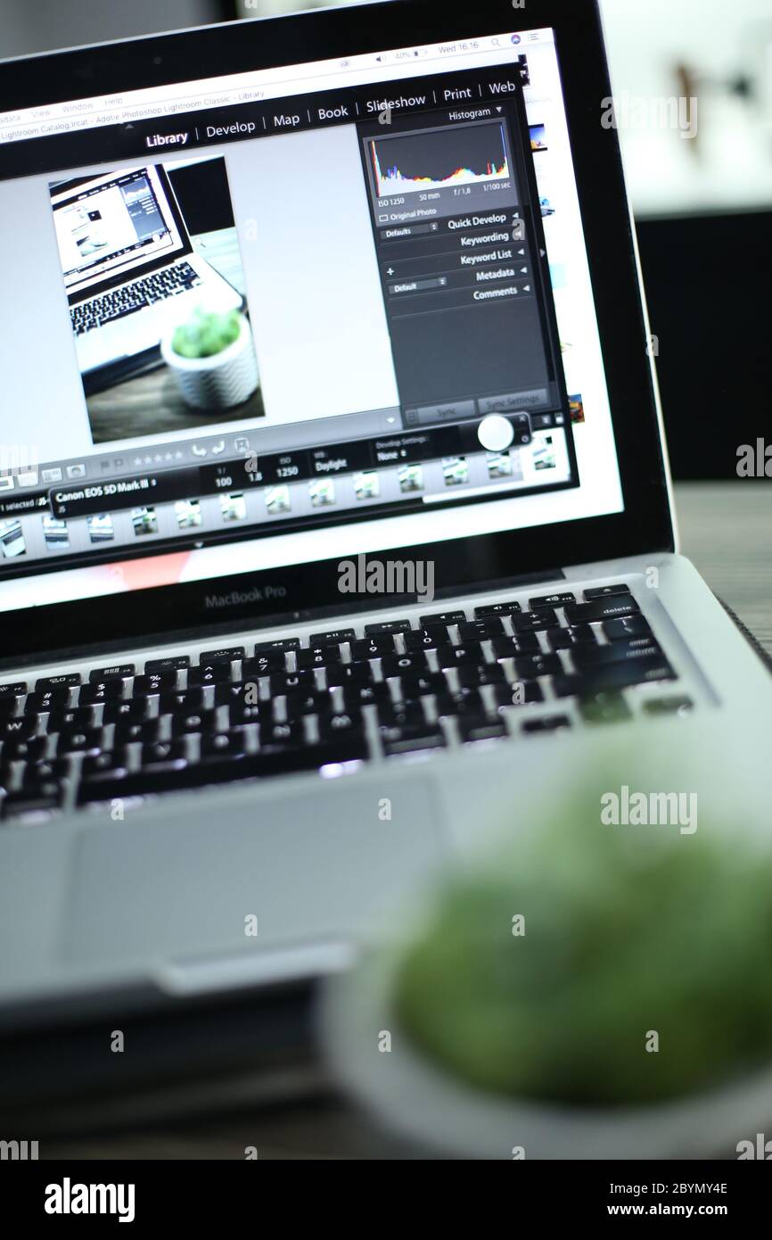 working with computer laptop, working with photo editing software Stock Photo
