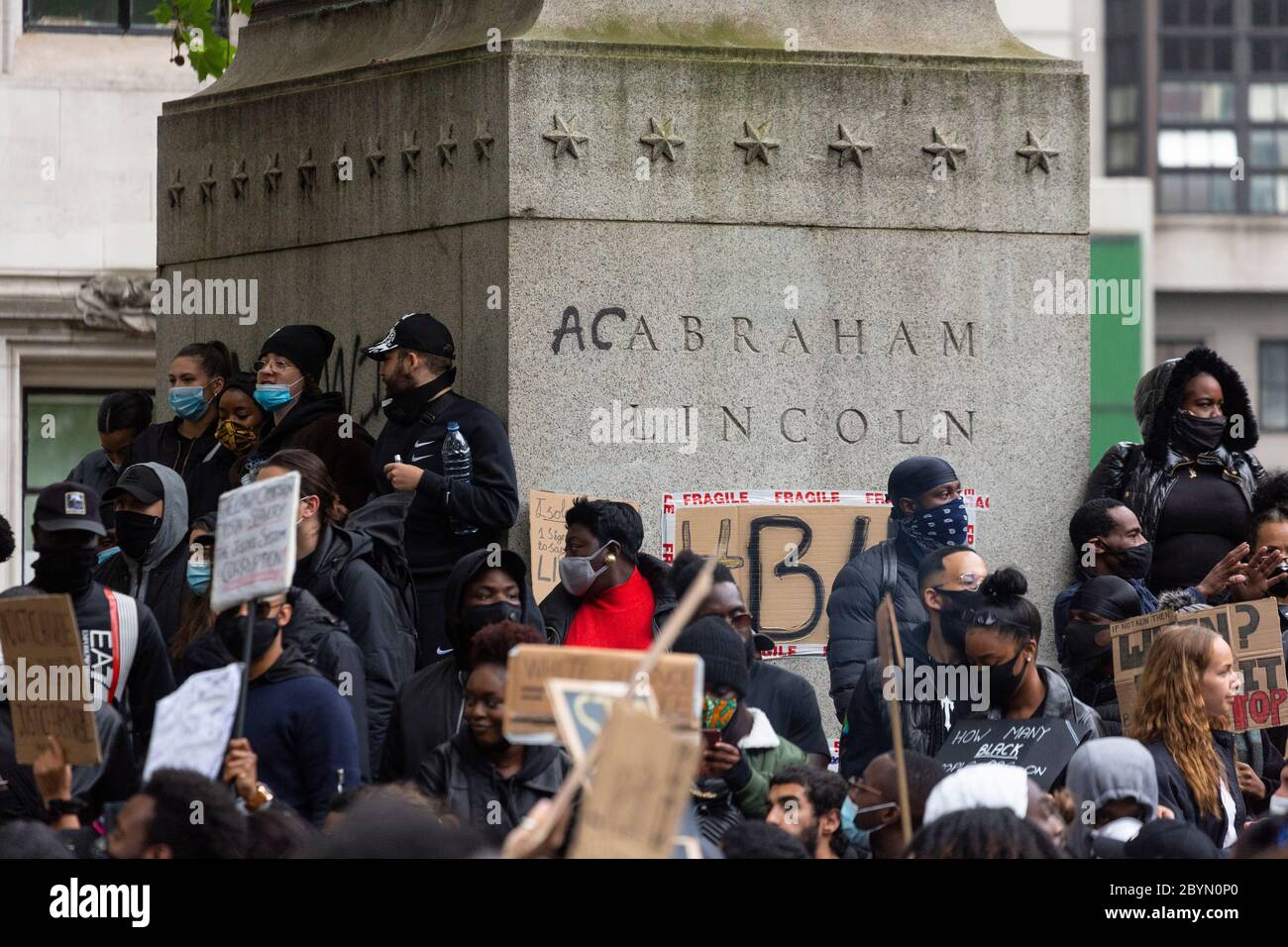Graffiti on the plinth of the statue of Abraham Lincoln in Parliament Square during a Black Lives Matters protest, London, 7 June 2020 Stock Photo