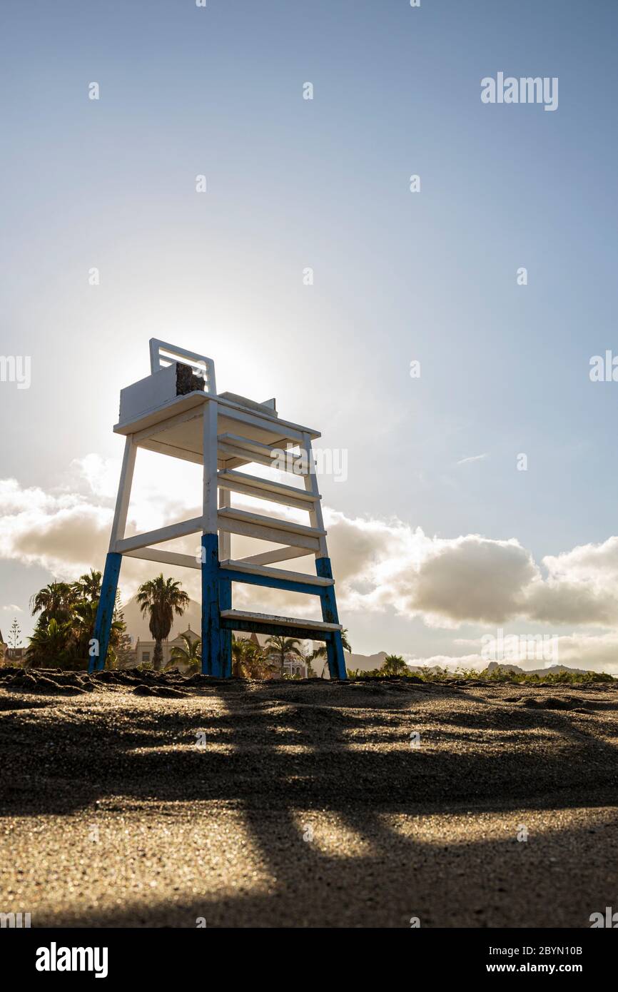 Low angle view looking up at a lifeguard lookout post with the morning sun behind, Playa del Duque beach, Costa Adeje, Tenerife, Canary Islands, Spain Stock Photo