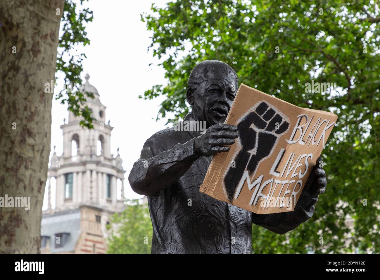 The statue of Nelson Mandela in Parliament Square with a sign in his hands, during a Black Lives Matters protest, London, 7 June 2020 Stock Photo