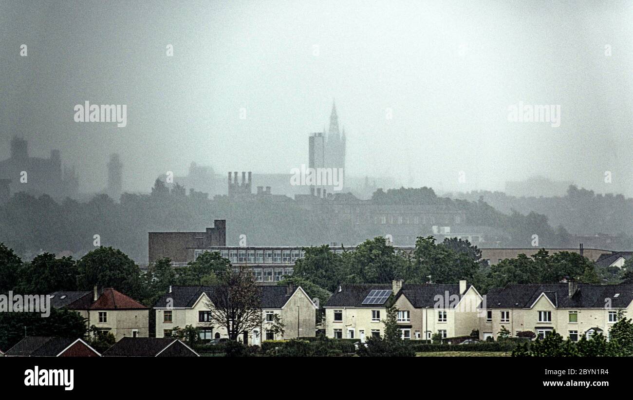 Glasgow, Scotland, UK 10th June, 2020: UK Weather: Torrential rain saw local landmarks ghosted in the distance with the heavy cloud darkness reigned. Credit: Gerard Ferry/Alamy Live News Stock Photo