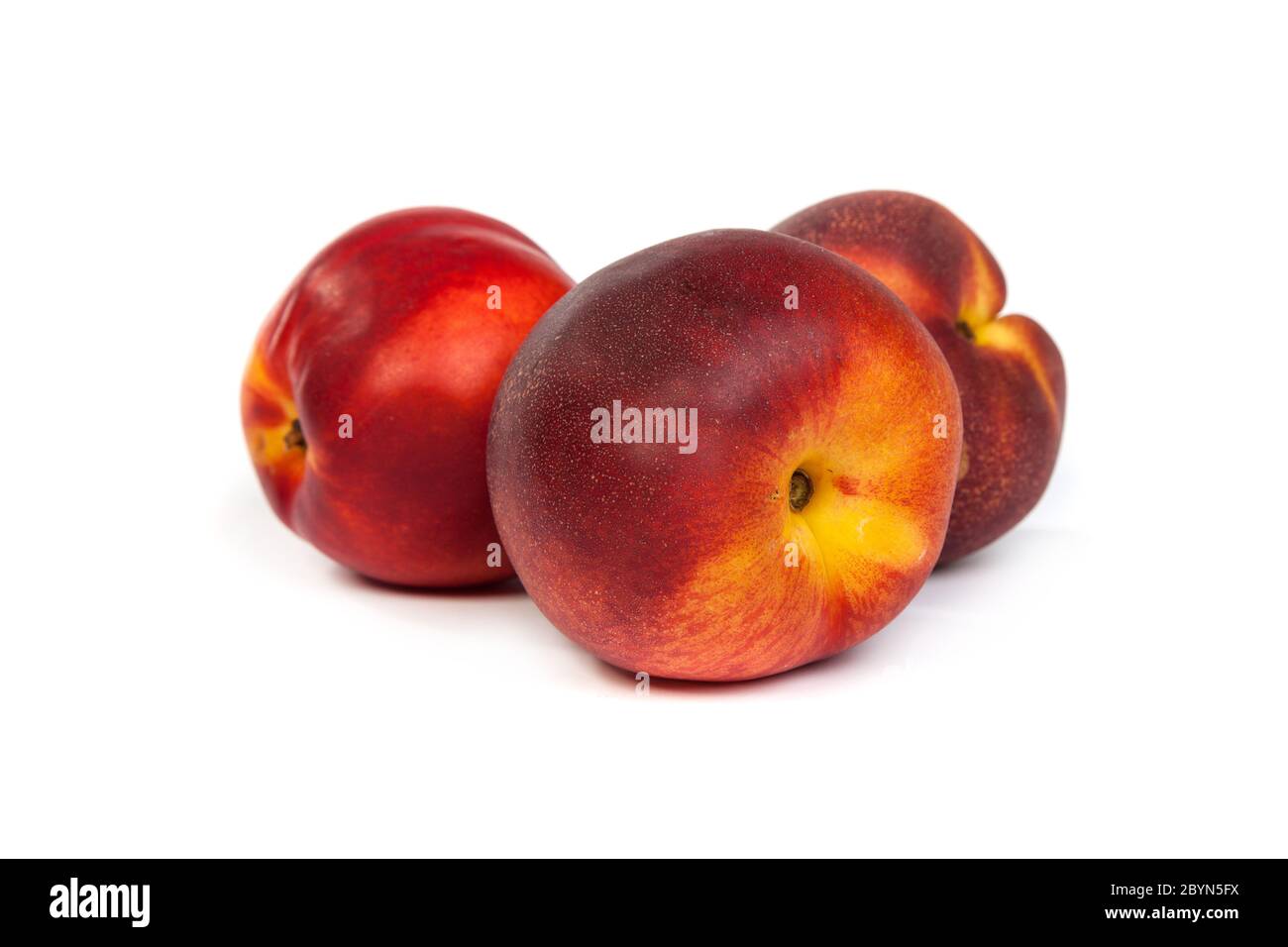 Three fresh nectarines on white Stock Photo