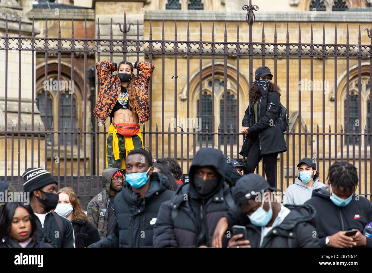 Two protesters climb the fence around the Palace of Westminster during a Black Lives Matters protest, Parliament Square, London, 7 June 2020 Stock Photo