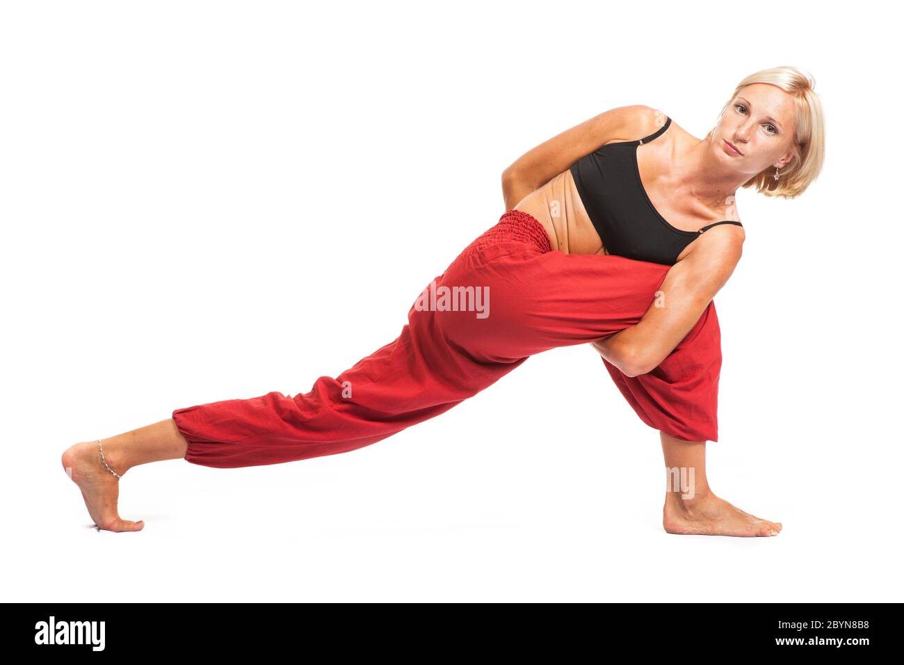 Practicing Yoga. Young woman isolated on white background Stock Photo ...