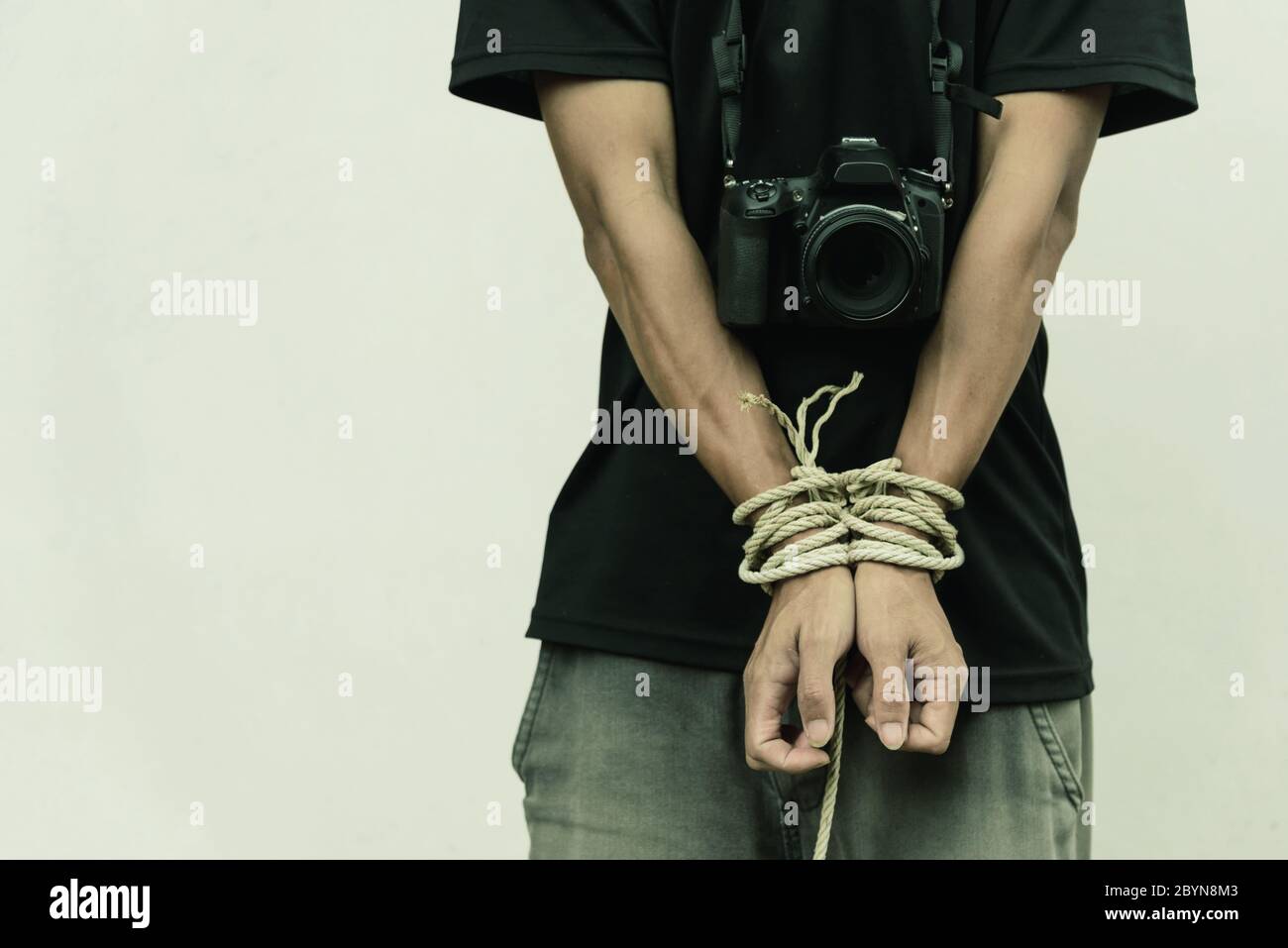 slave photographer / photographer has bundle by rope Stock Photo