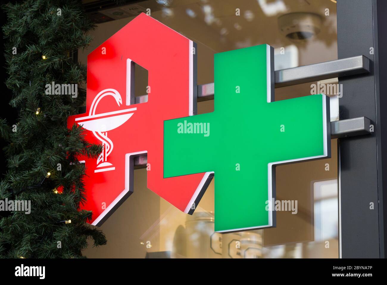Close up of Apotheke (pharmacy / apothecary) sign / logo. Red 'A' and green cross. Stock Photo