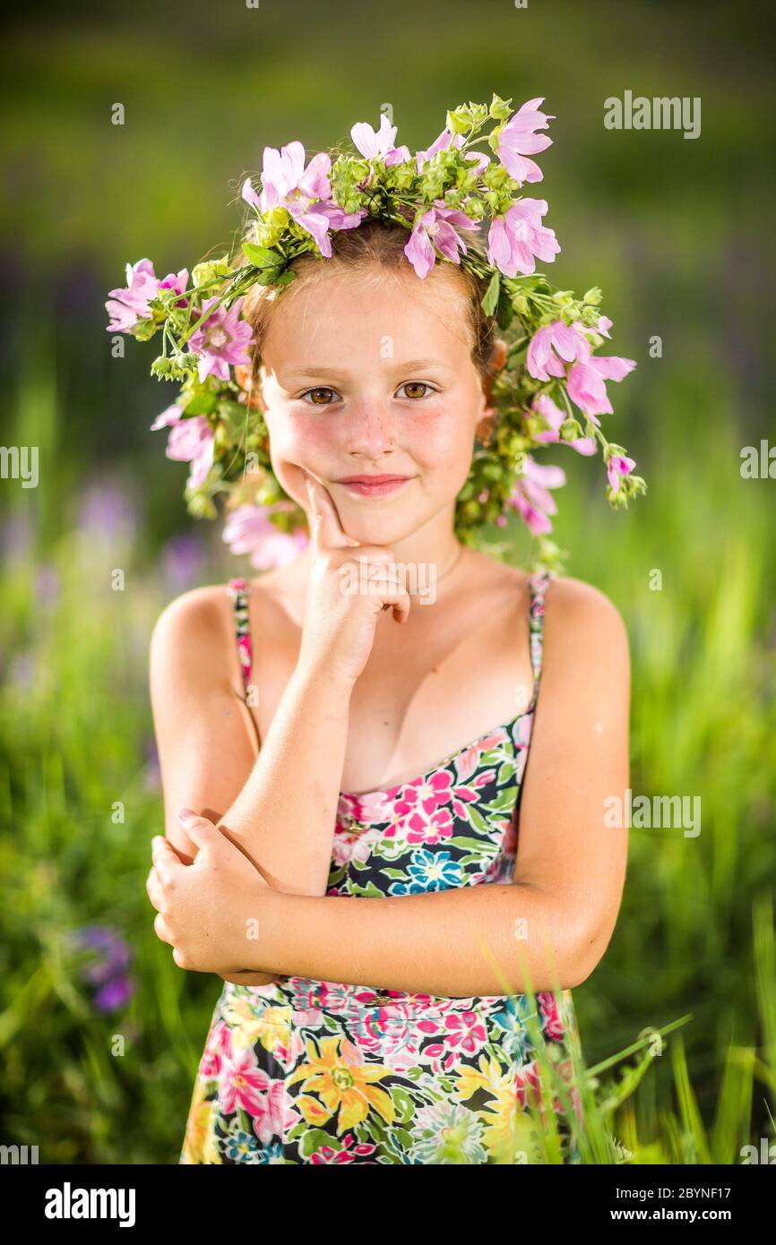 Portrait of a little girl in wreath of flowers Stock Photo - Alamy