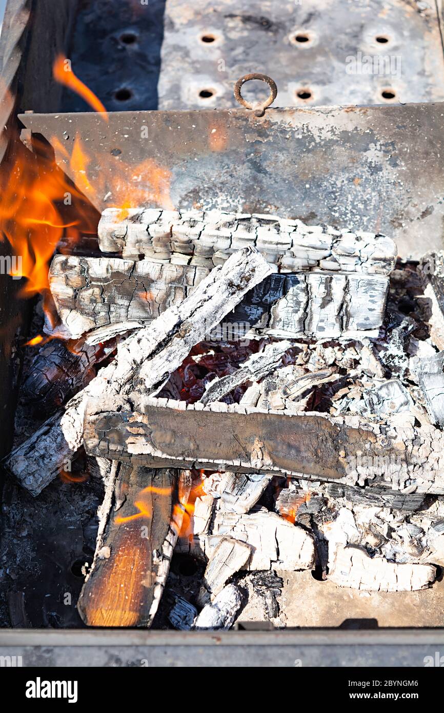 Burning firewood for bbq grill grate Stock Photo Alamy