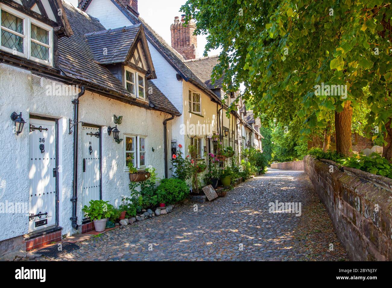 View of old country cottages along an old cobbled lane in the Cheshire rural country  village of Great Budworth Cheshire England UK Stock Photo