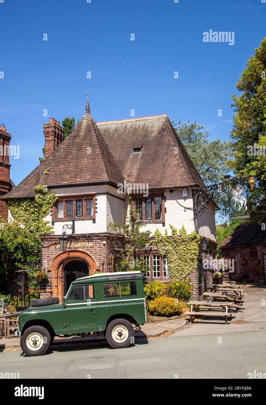 Green Land Rover Defender outside the old English Inn pub of George and Dragon at Great Budworth Cheshire England UK Stock Photo
