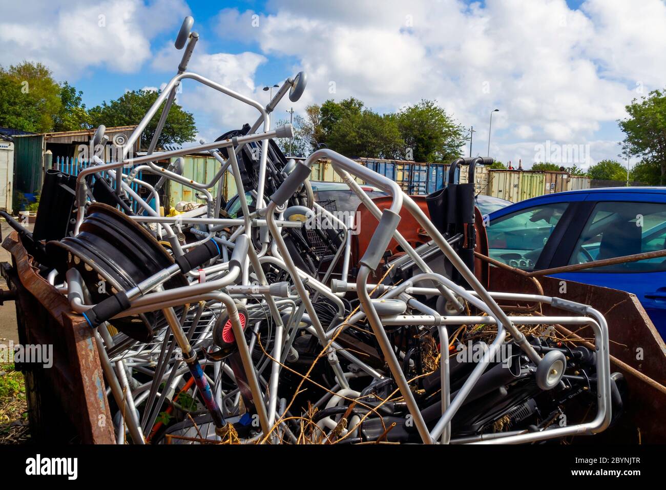 Scrap metal in a skip mainly zimmer frames or personal walking aids for disposal Stock Photo