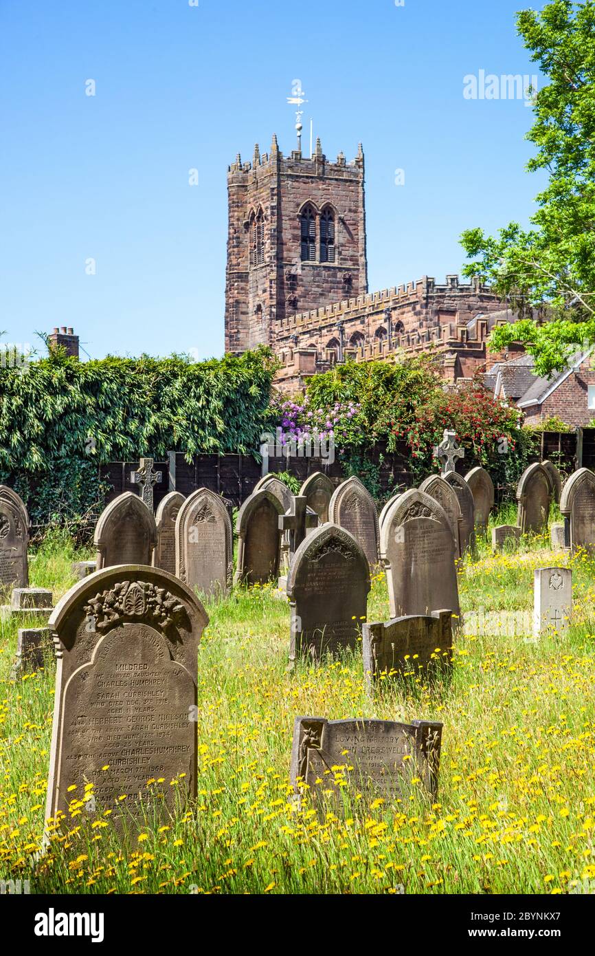 View of the country village church of St Mary and All Saints' Church, great Budworth Cheshire England UK through the churchyard gravestones Stock Photo