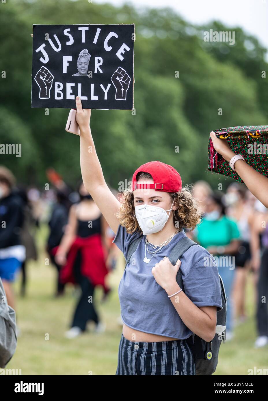 London, UK. 3rd June, 2020. Thousands of people protest in Hyde Park in solidarity with Black Lives Matter. A young person wearing a mask holds up a banner stating 'justice for Belly'.The US has been rocked by days of protest across many cities, after George Floyd, a black man, died in police custody on 25th May in Minneapolis.  credit Carol Moir/Alamy News Stock Photo