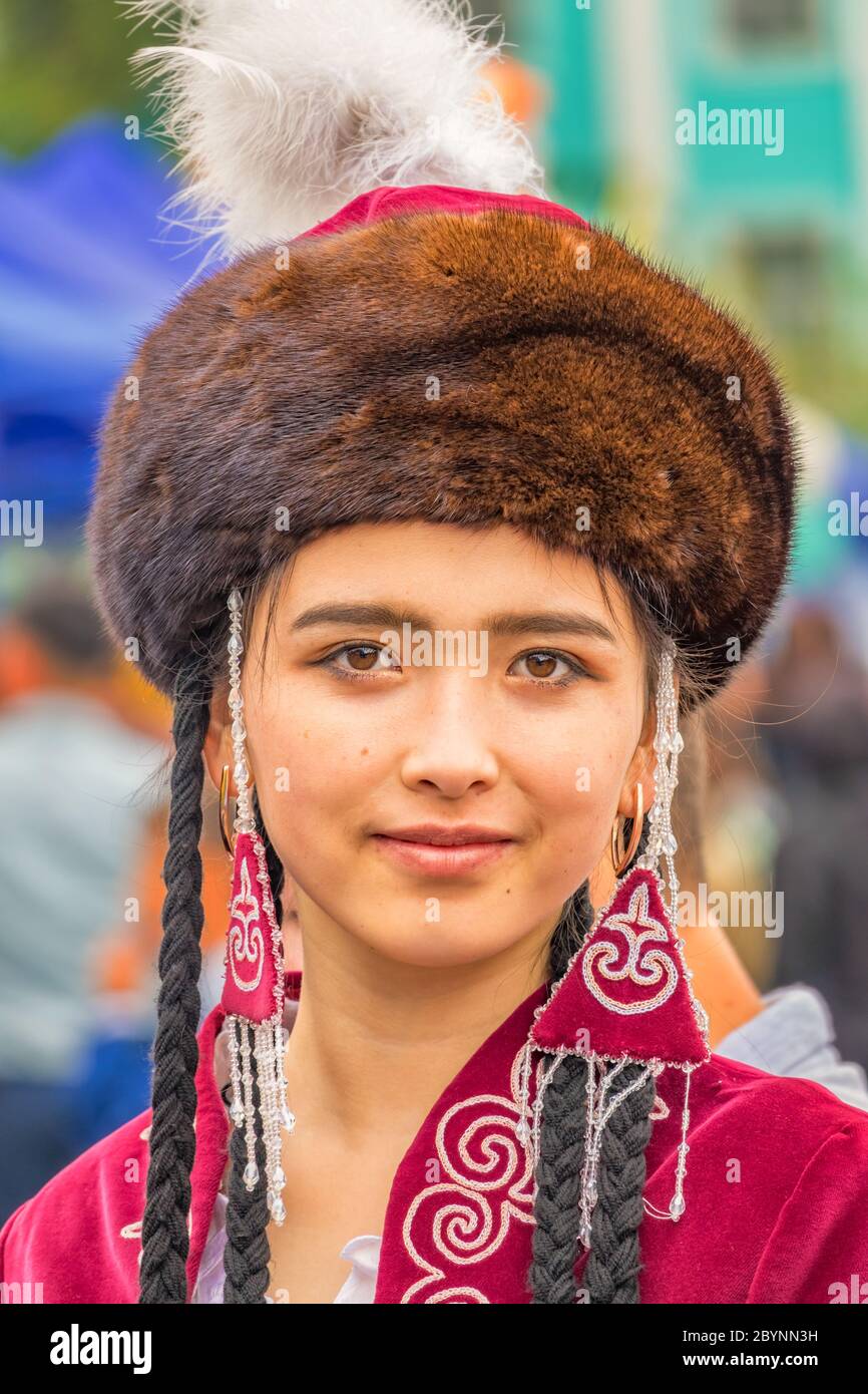 Young woman in traditional clothing during a festival in Osh Kyrgyzstan Stock Photo