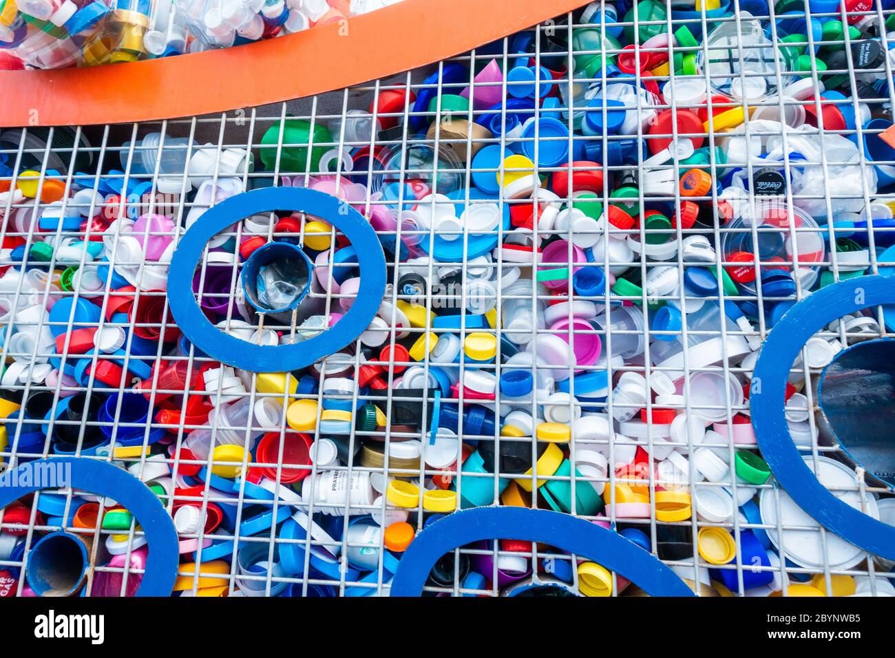 Plastic bottle tops recycling collection point in street in Spain Stock