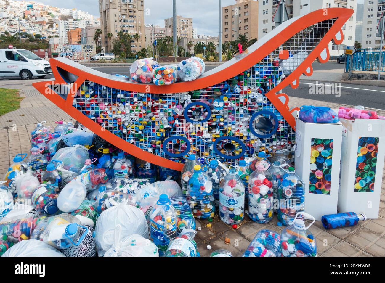Plastic bottle tops recycling collection point in street in Spain Stock