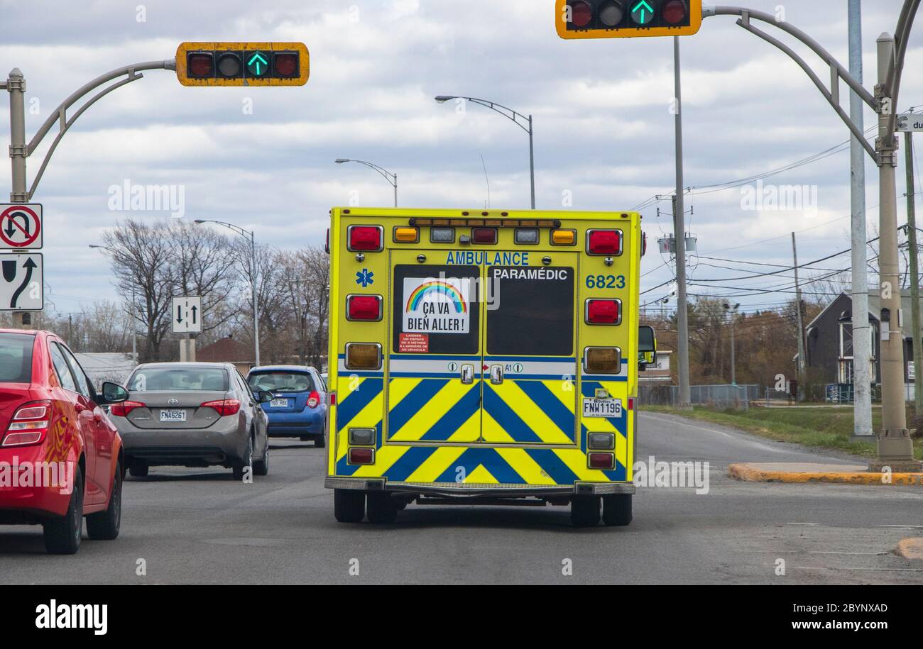 May 10, 2020 - Saint-Constant, Qc, Canada: Rear view of ambulance with rainbow sticker 'Ça va bien aller' french hope message in the window Stock Photo