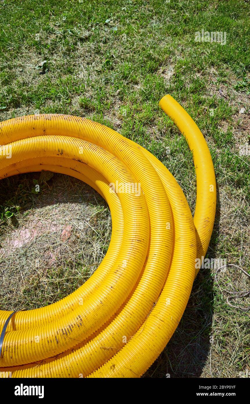 Yellow coil land drainage pipe on the ground, used to remove excessive