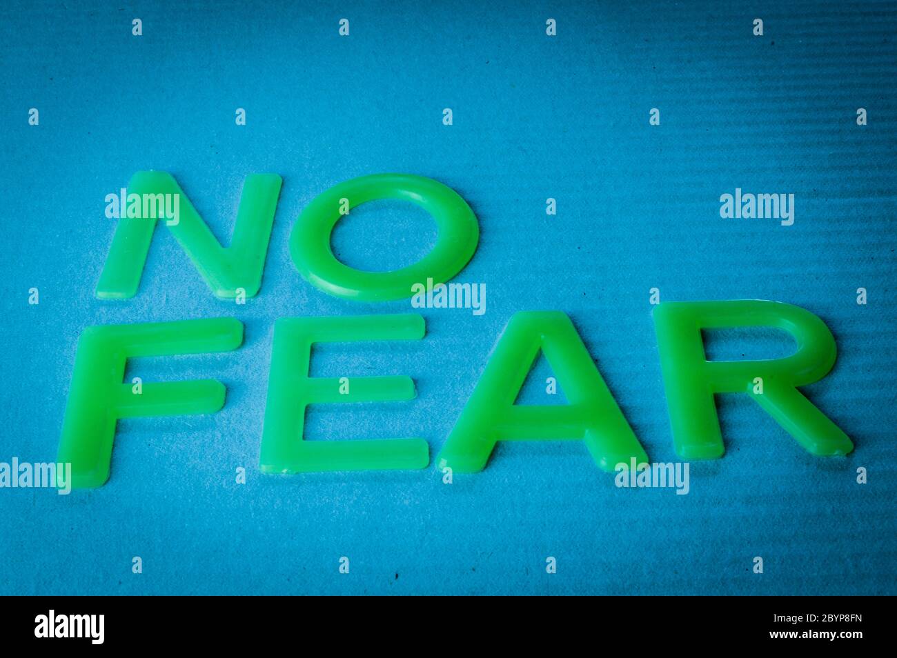No Fear Motivation Concept - Words made by green letters on blue background. Stock Photo