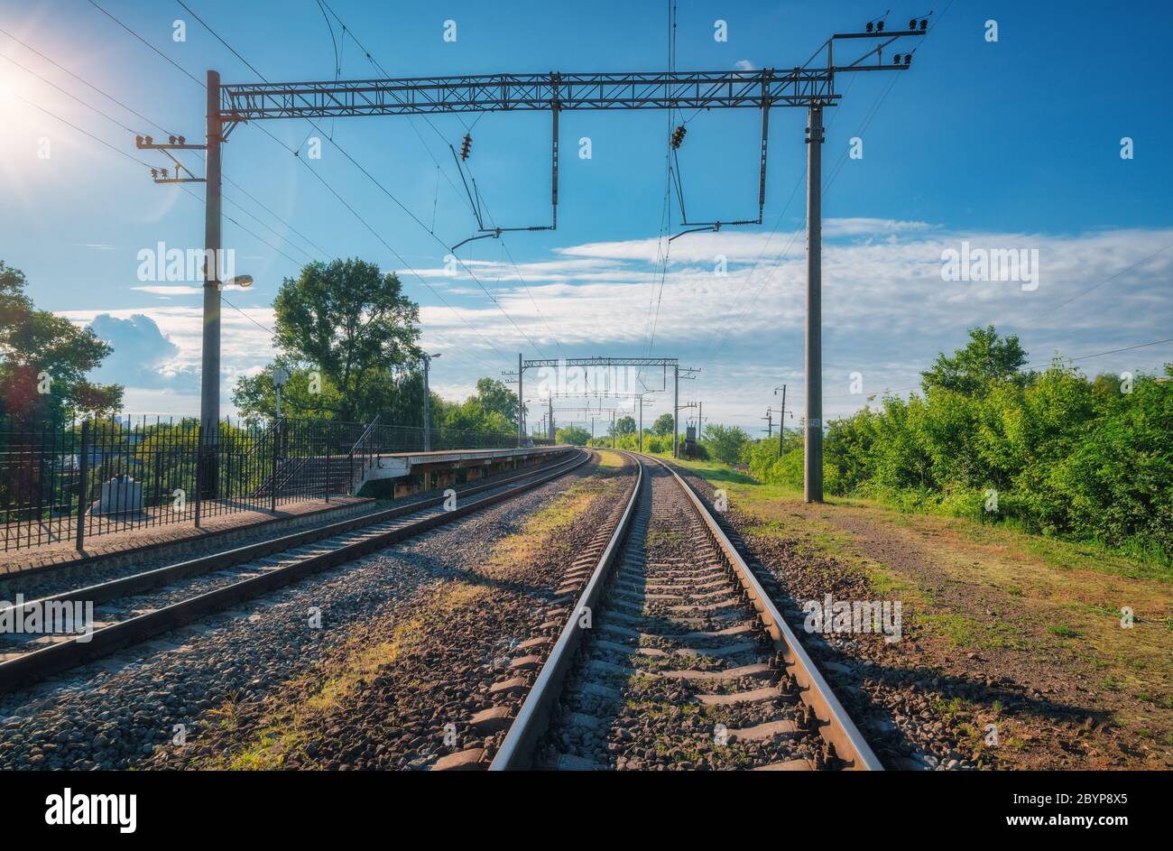 Railway station at bright sunny day in summer. Railroad in Europe Stock Photo