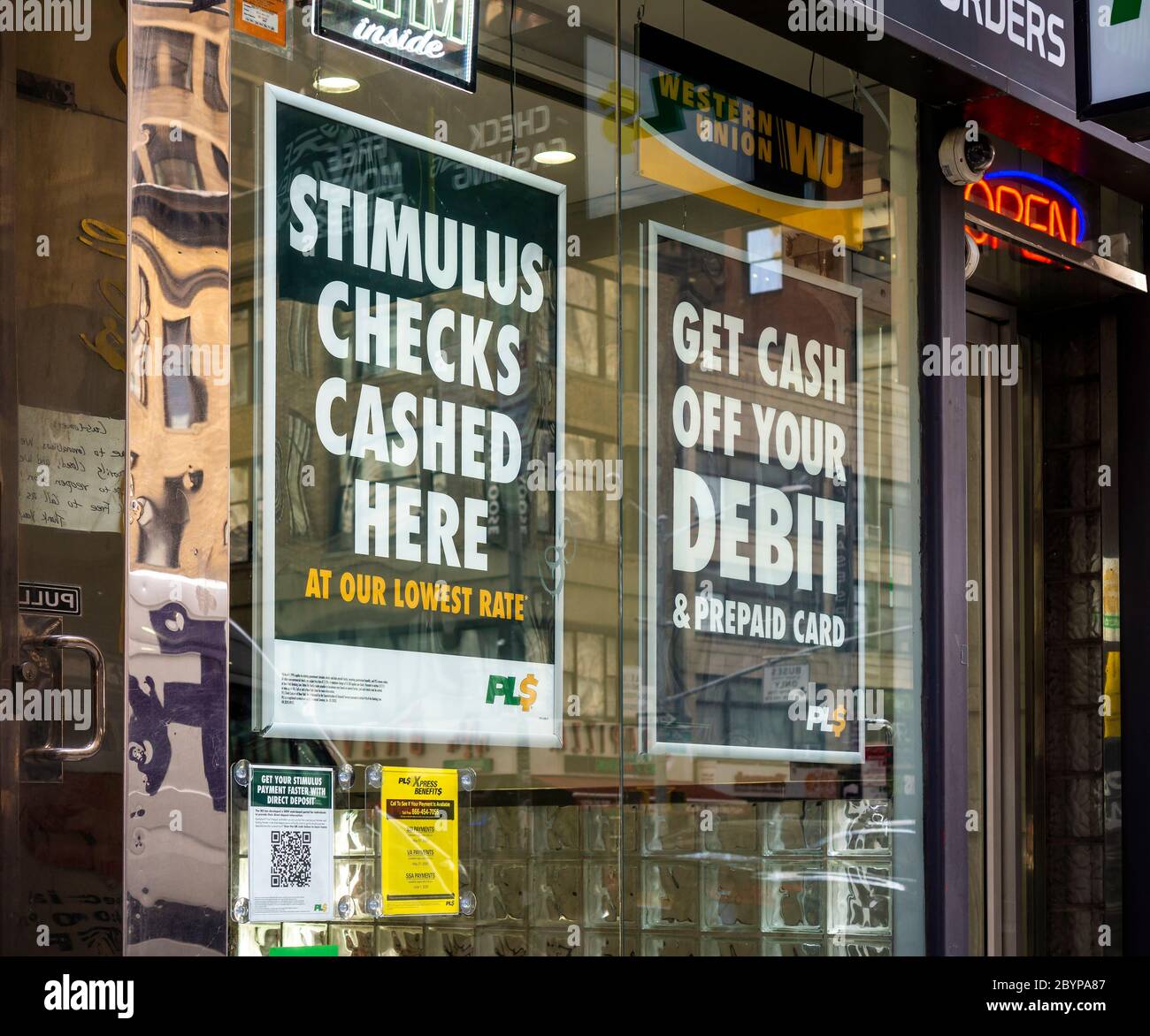 A check cashing business in New York on Friday, May 29, 2020 advertises that they cash stimulus checks. (© Richard B. Levine) Stock Photo