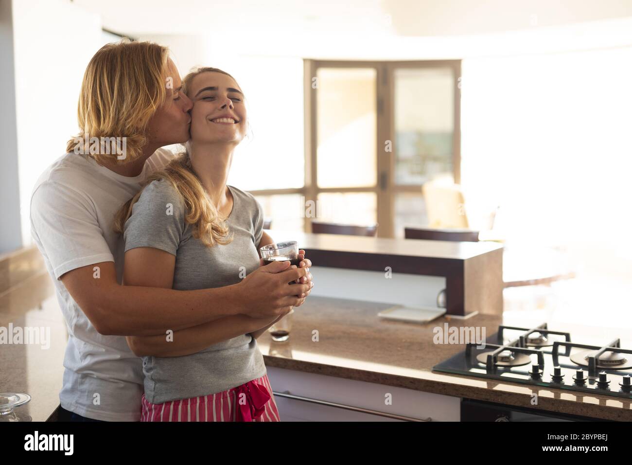 Caucasian couple in a kitchen during quarantine lockdown for coronavirus Covid19 pandemic Stock Photo