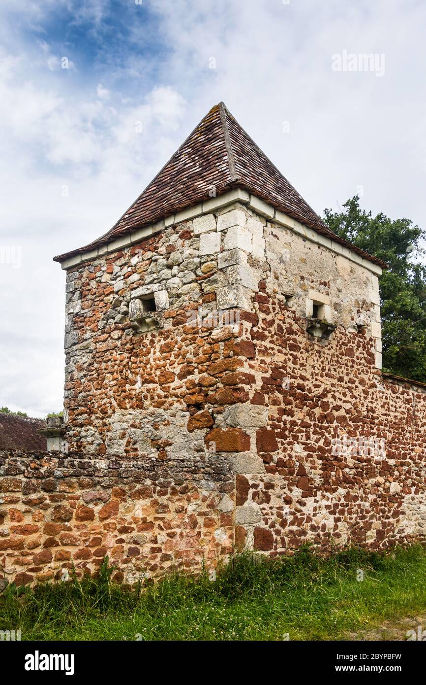 Old pigeonnier (pigeon house) tower in Le Bouchet showing red iron-content in the local stone, Brenne, Indre, France. Stock Photo