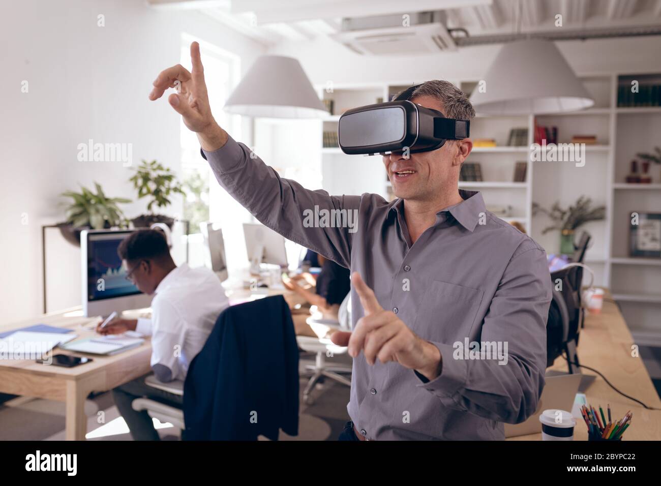 Caucasian businessman testing VR at work Stock Photo