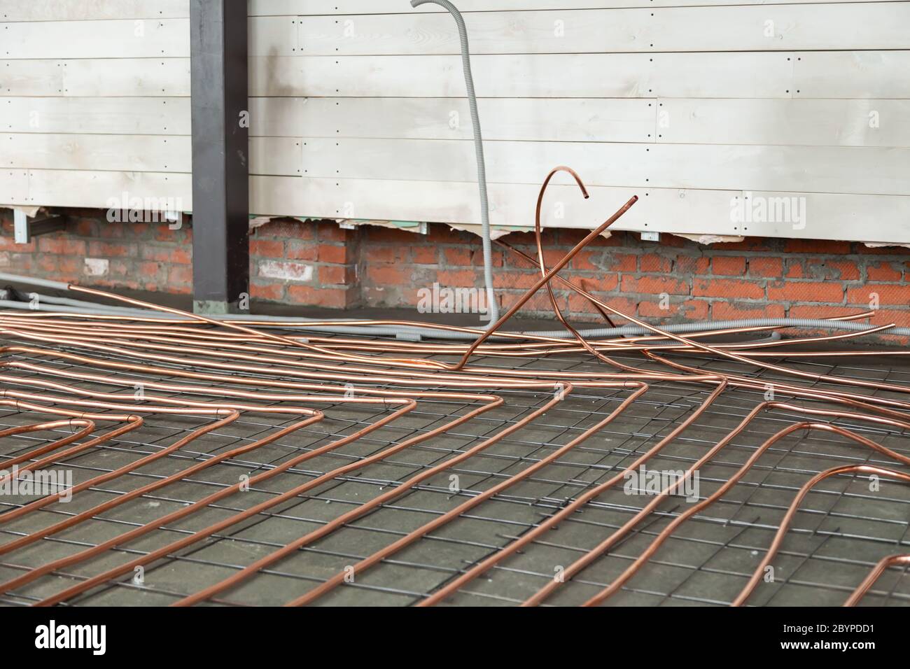Bent new copper pipes laying on concrete floor Stock Photo Alamy