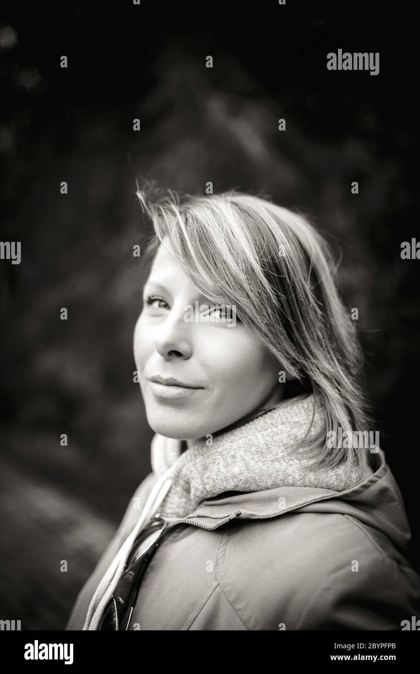 Outdoor portrait of a young cute woman, natural light, black and white ...