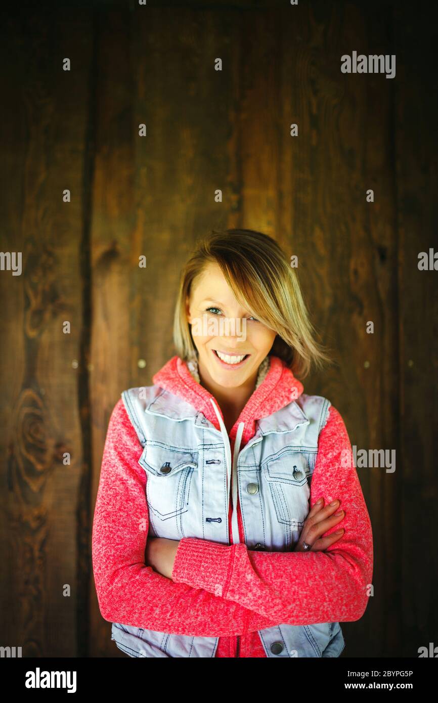 Portrait of a young woman in front of wooden wall, natural light Stock ...