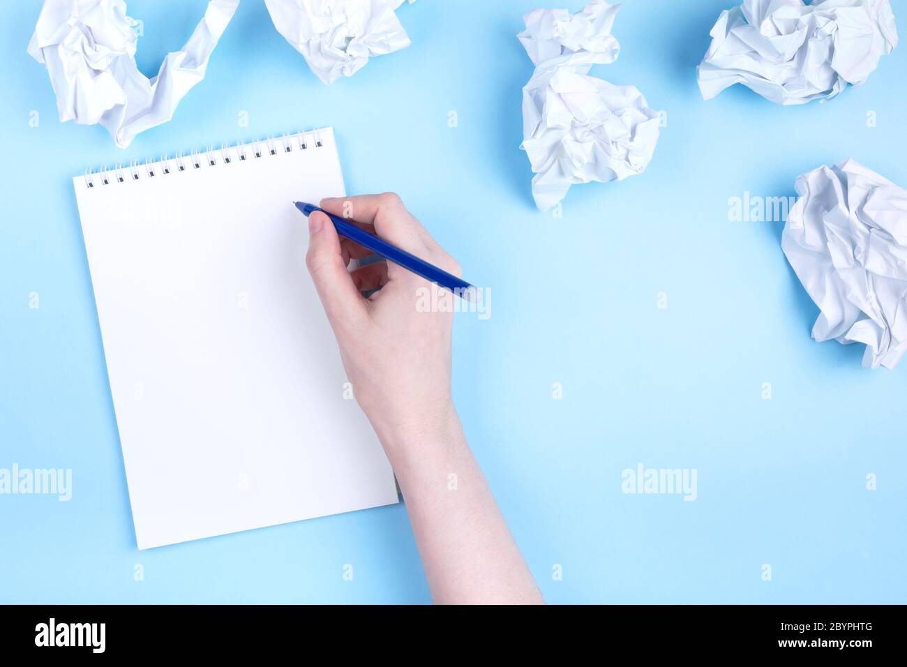 Woman Writes In Notebook Around Crumpled Paper Blue Background Concept Of Beginning To Draw Up Plan Discarding Bad Ideas Flat Lay Copy Space Stock Photo Alamy