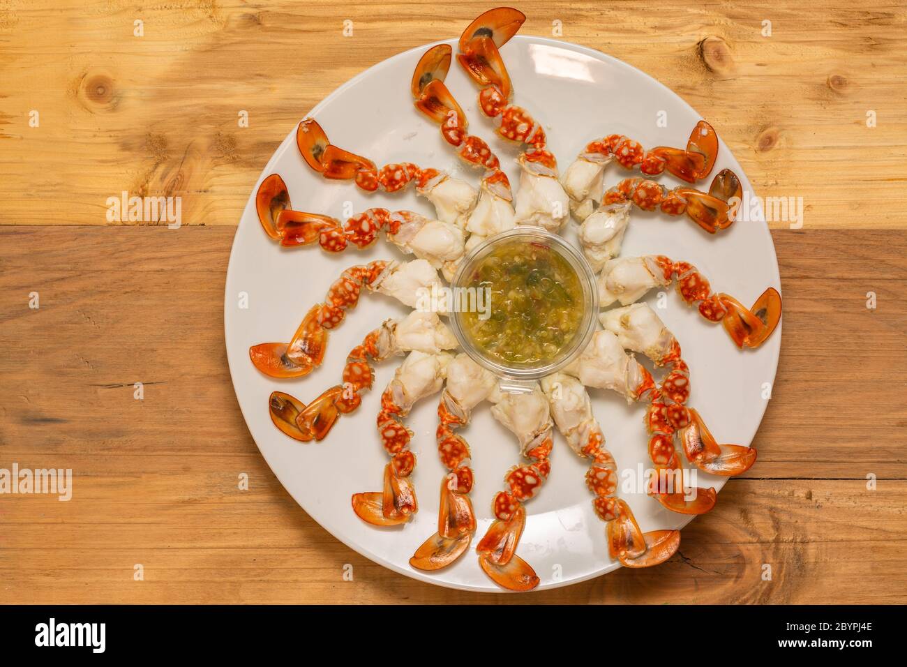 Fresh steamed crab select crab claw on a plate with seafood sauce ready